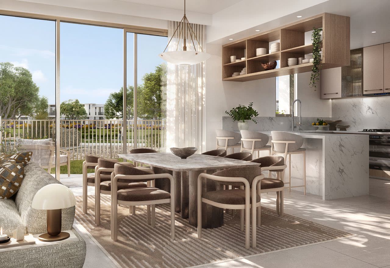 Dining area and open kitchen with island seating and a garden outlook